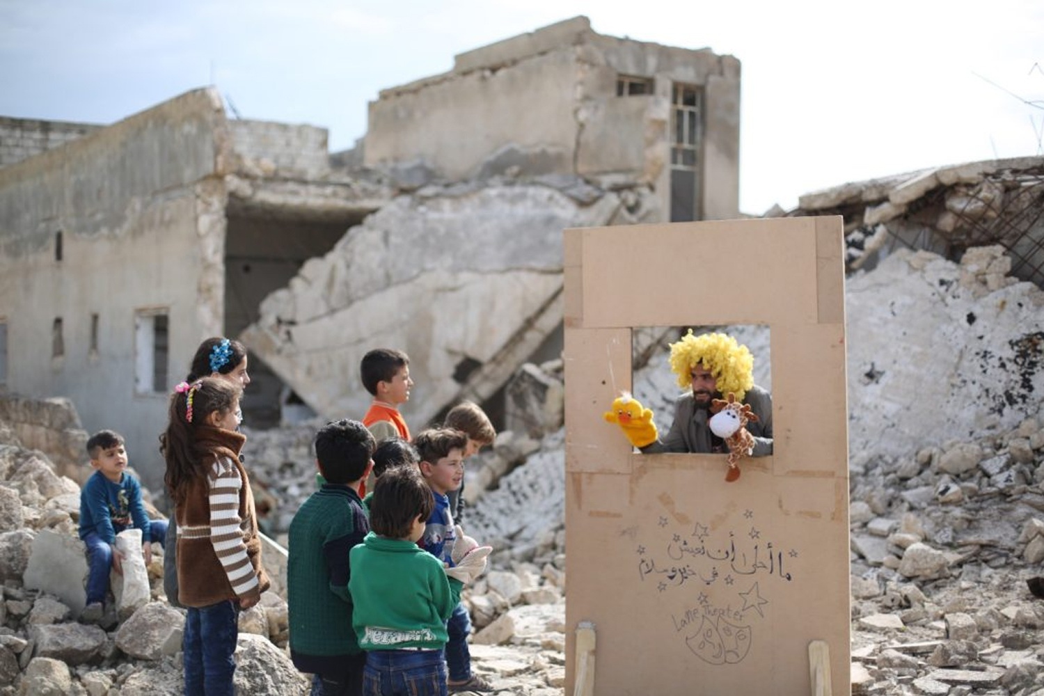 Children watch a puppet show in Syria. Photo: Walid Abo Rashed. Centre for Arts and Social Transformation, University of Auckland.